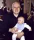 Thomas at his christening - with proud father - February 2003